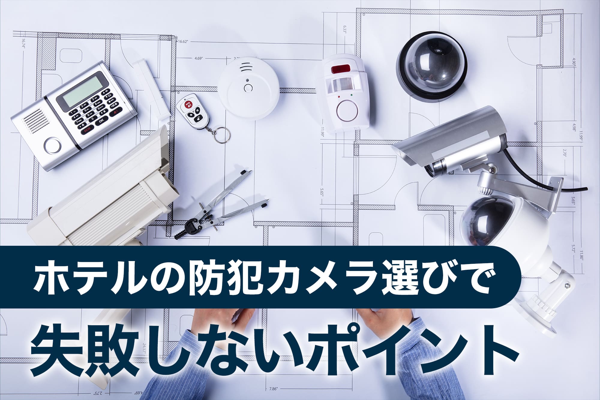 図面の上に並べられた防犯カメラとセキュリティ機器
